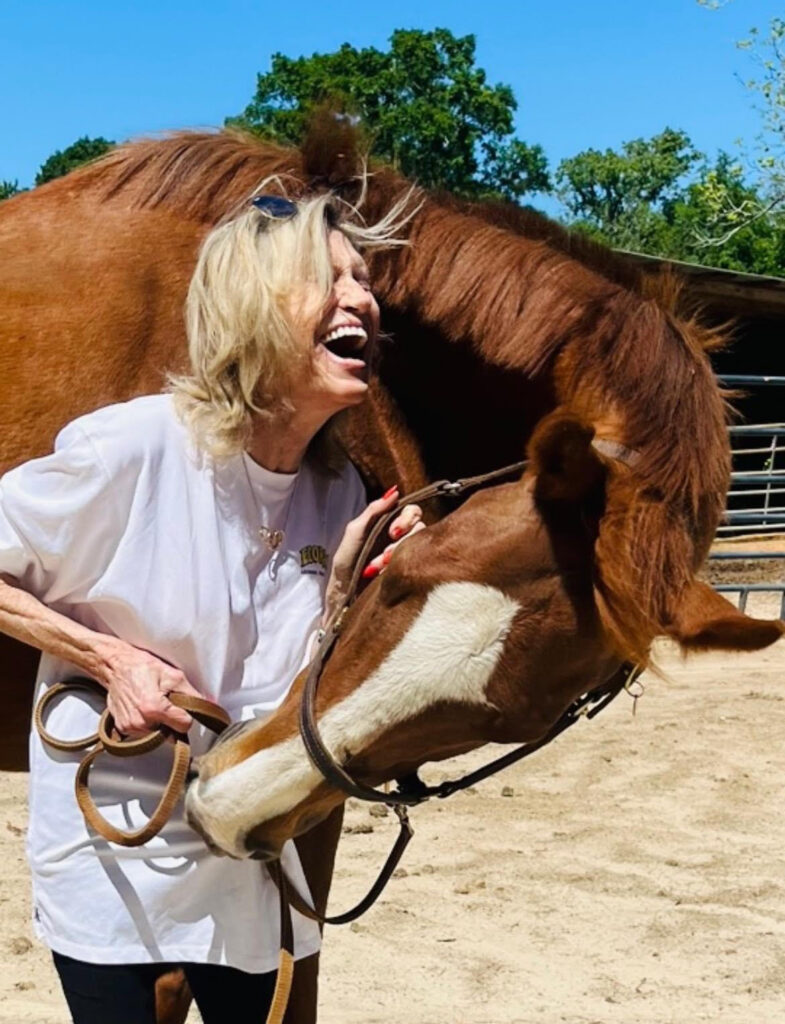 Lady laughing with Tea, the healing horse